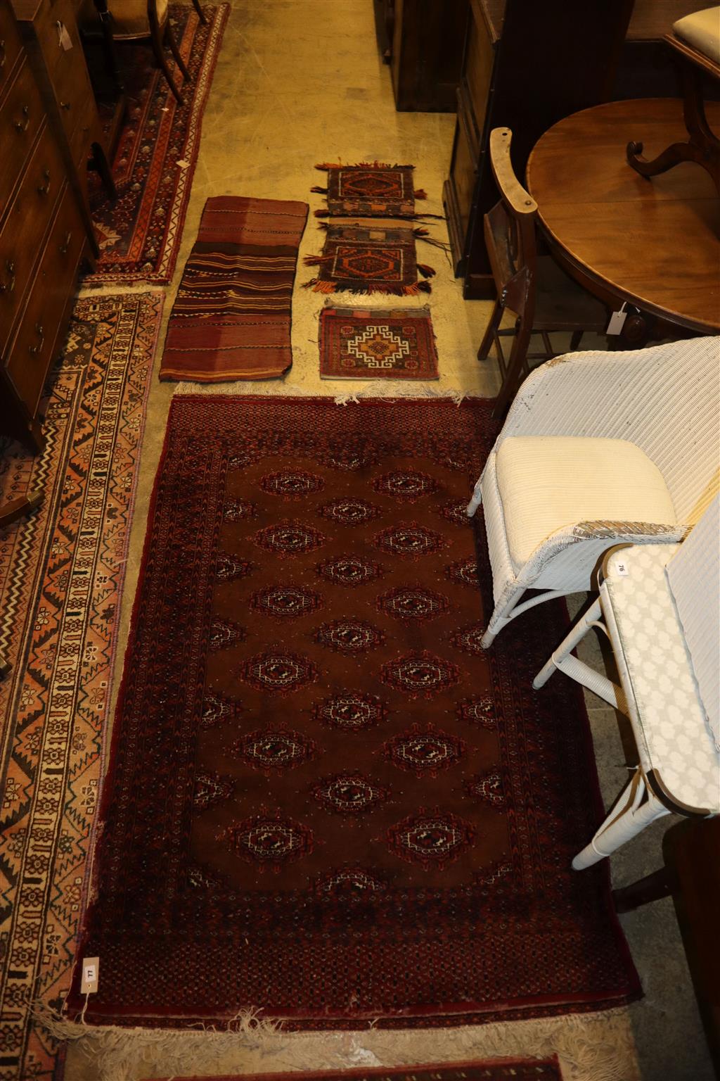 A Bokhara rug, 184 x 125cm together with a mat and three saddlebags
